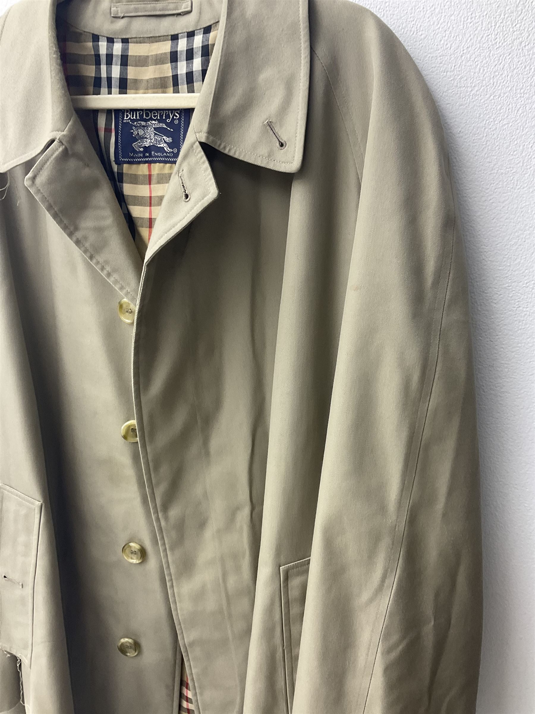 Ladies Burberry double breasted trench coat, with belt and detachable woollen gilet, in traditional cream colour with Burberry check lining, together with a gentlemans Burberry single breasted trench coat, both L112cm