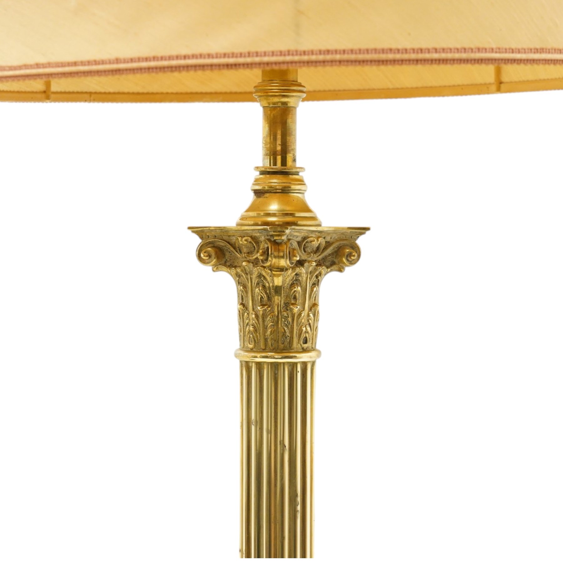 Late Victorian Neoclassical brass standard lamp with shade, the composite Ionic and Corinthian acanthus capital over a reeded column, terminating to a stepped platform base with applied festoon ornament, raised on four scrolling ball-and-claw feet
