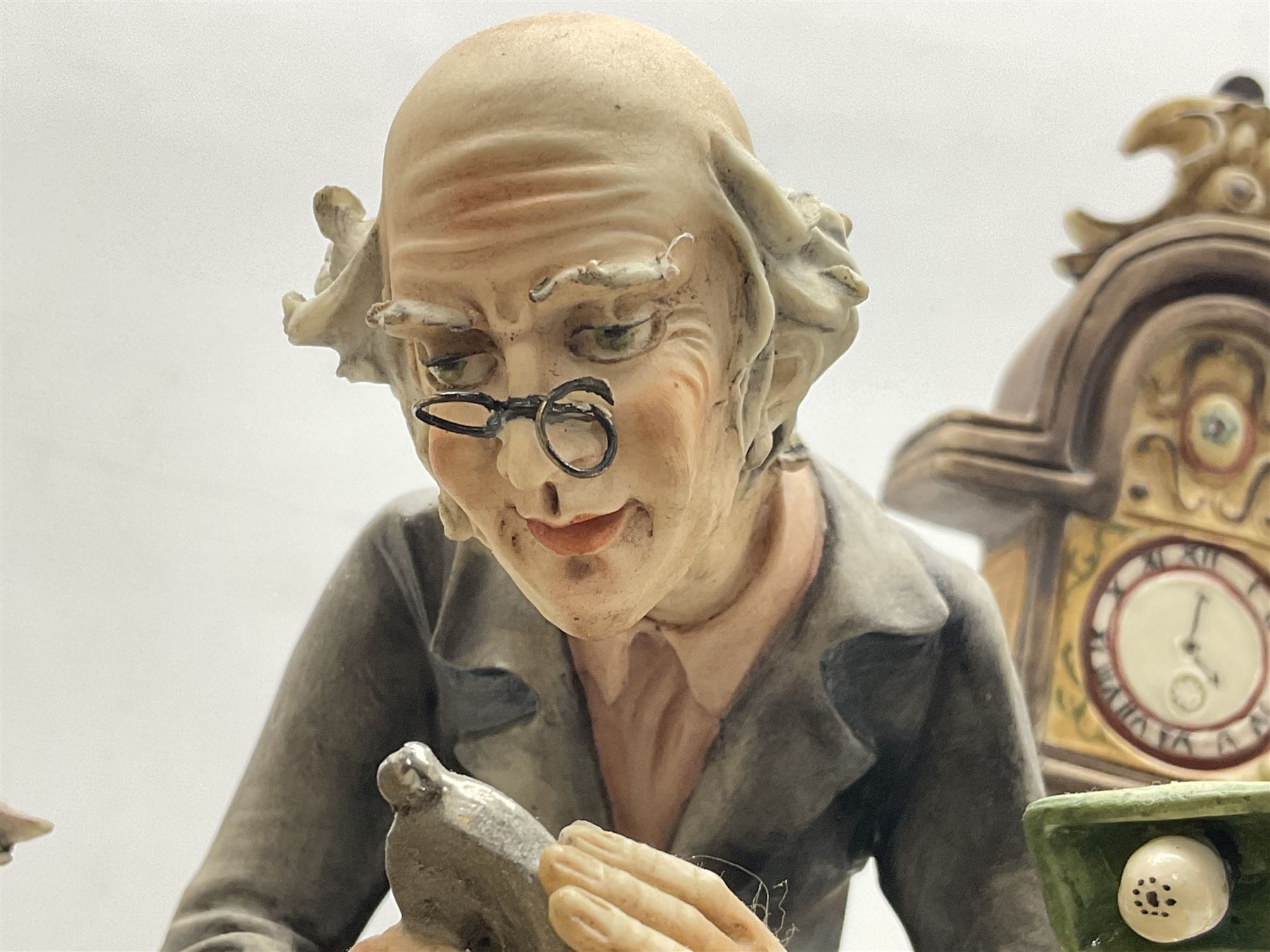 Two Capodimonte figures, comprising The Watchmaker by Curiase and Tramp Seated on a Bench, created by D.Bonalberti, tallest example H24cm