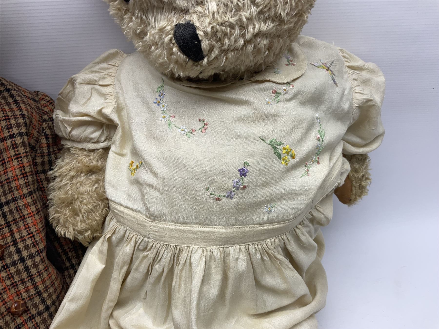 Two early 20th century straw filled jointed teddy bears, first example wearing a tweed jacket bearing Geoffrey Saville label, with leather padded paws and ears, horizontally stitched nose and humpback; second example with applied eyes, vertically stitched nose and faux leather paw pads, both with growler mechanisms, tallest H74cm 