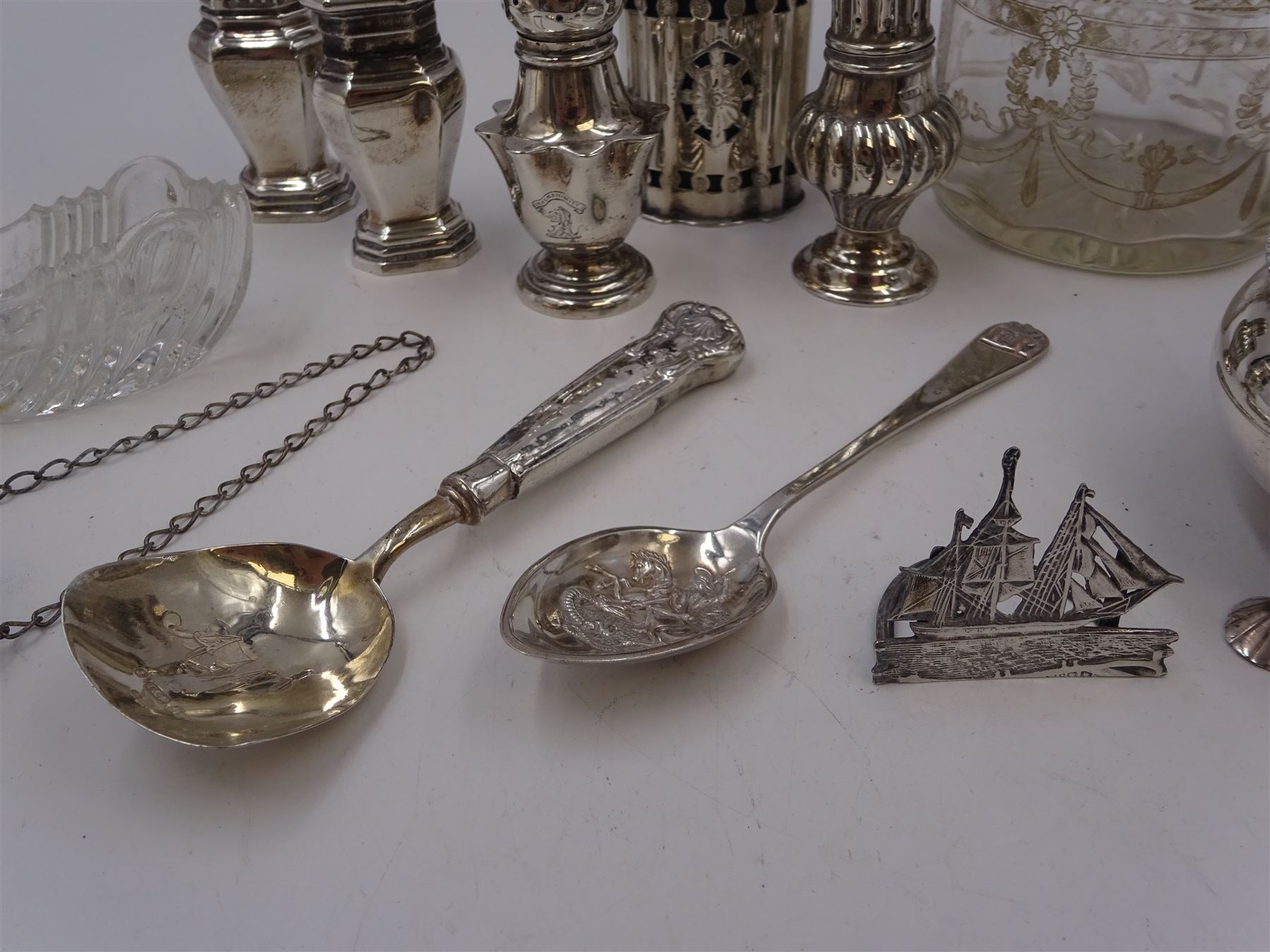 Group of silver, to include Edwardian silver open salt, of circular bellied form, with gadrooned rim, upon three shell feet, hallmarked Mappin & Webb Ltd, London 1906, together with a blank decanter label, repousse decorated with fruiting vines, hallmarked W I Broadway & Co, Birmingham 1995 and five silver pepper shakers, all hallmarked with various dates and makers, etc 
