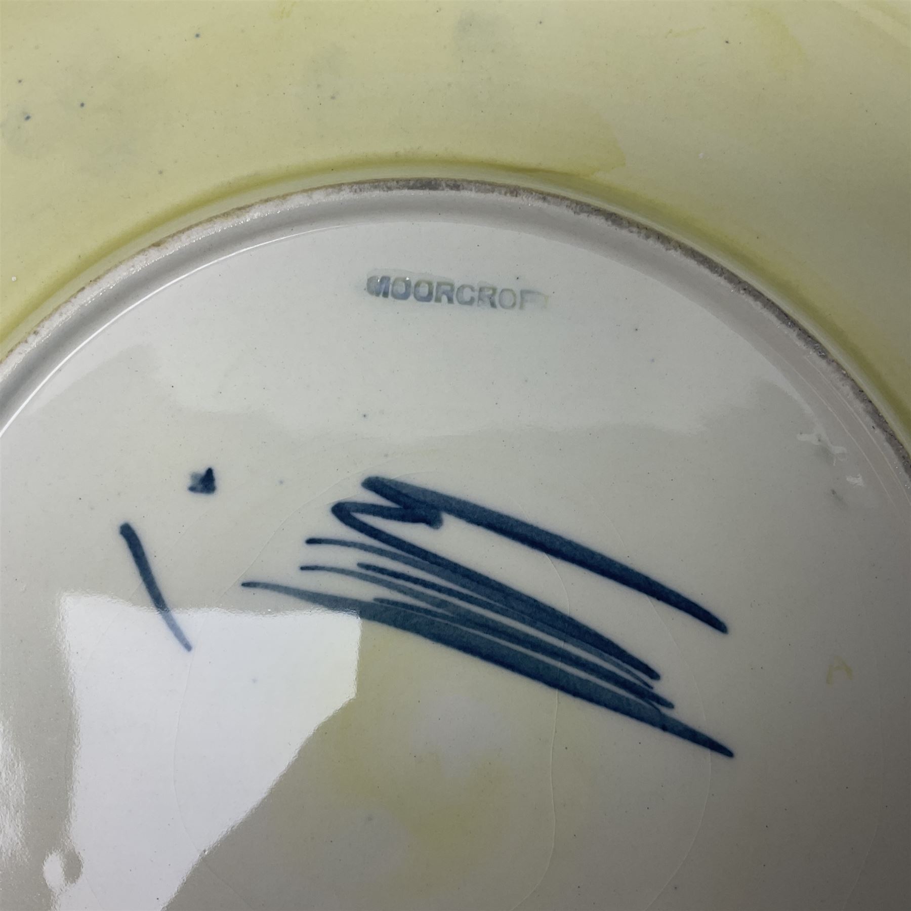 Moorcroft Tiger Lily pattern plate on a yellow ground, with painted and impressed mark beneath, D26cm