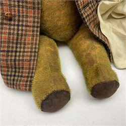 Two early 20th century straw filled jointed teddy bears, first example wearing a tweed jacket bearing Geoffrey Saville label, with leather padded paws and ears, horizontally stitched nose and humpback; second example with applied eyes, vertically stitched nose and faux leather paw pads, both with growler mechanisms, tallest H74cm 