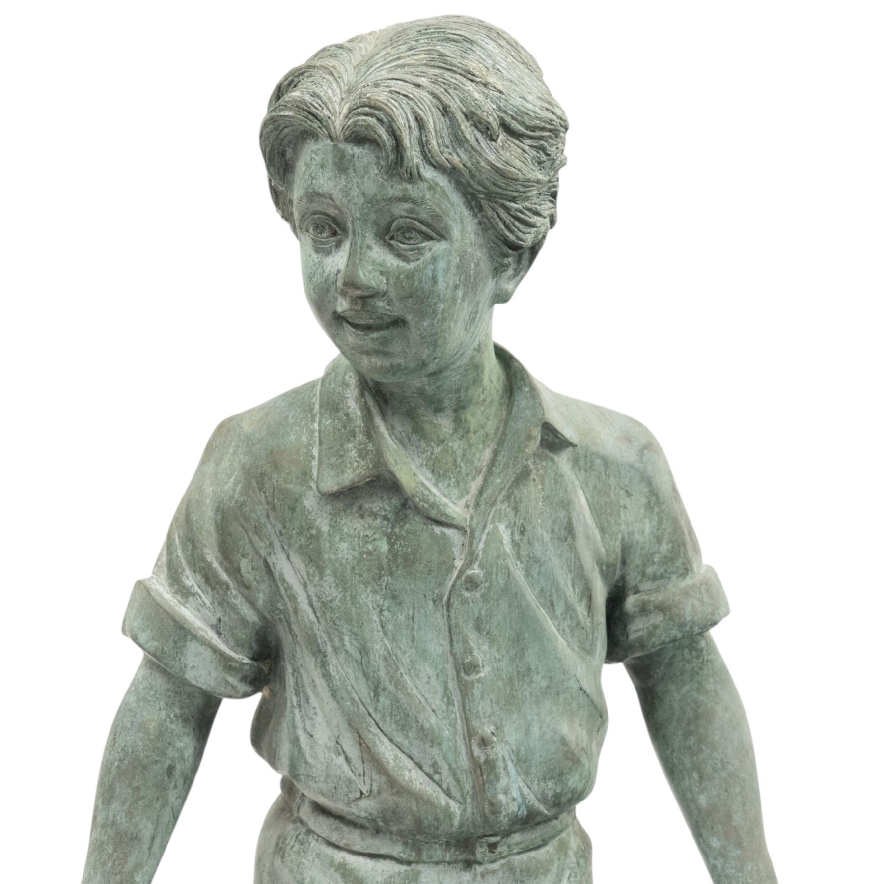 After Eneri Prosperi, bronze garden child statues, depicting children balancing on rock-form bases, the boy in shirt and shorts, the girl in dress with raised arms, surrounded by loose rounded pebble elements