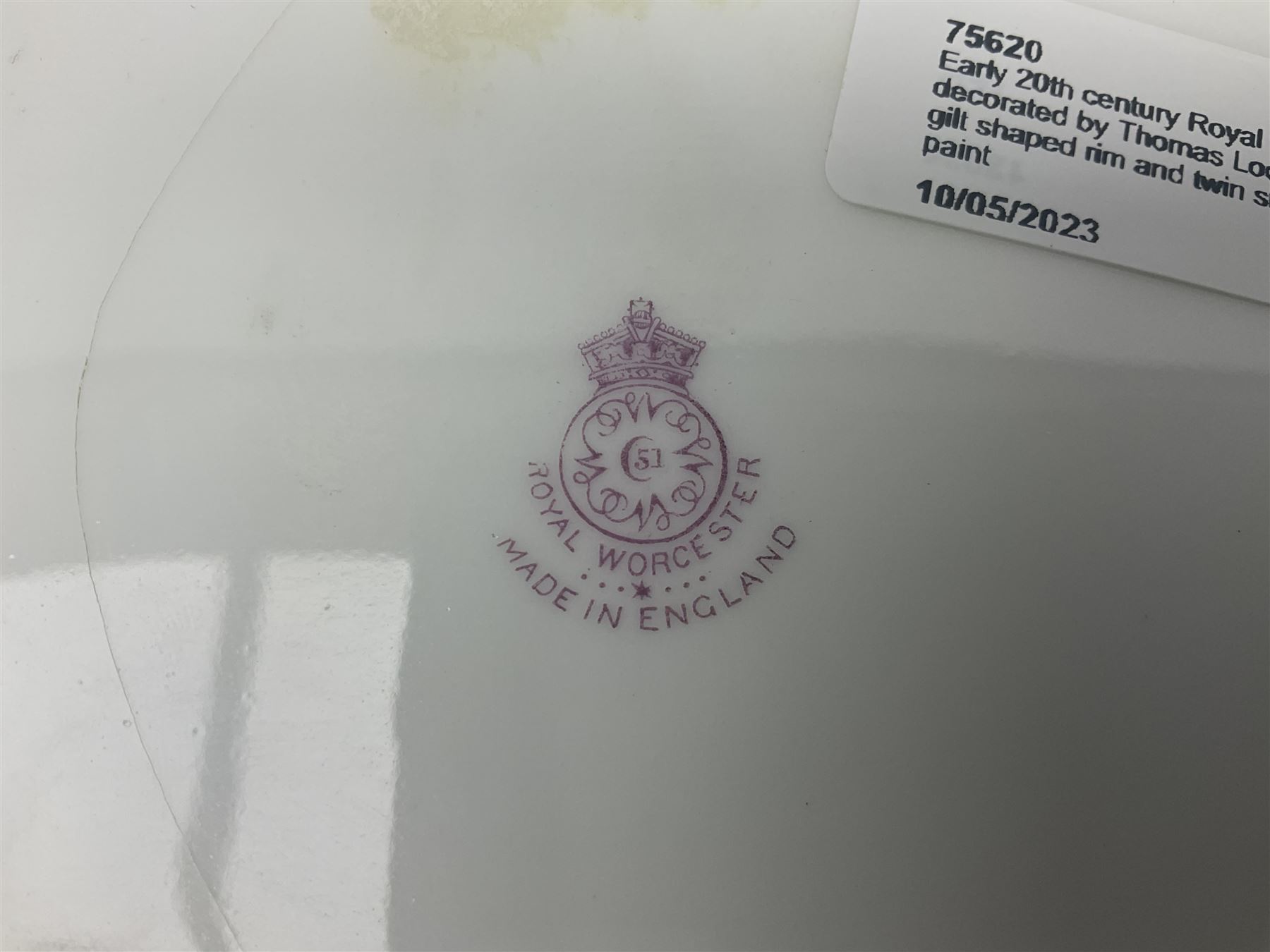 Early 20th century Royal Worcester dish decorated by Thomas Lockyer, oval form with gilt shaped rim and twin shell handles, hand painted with a still life of fruit upon a mossy ground, signed T Lockyer, with puce printed mark beneath and date code for 1922, for restoration, W31cm