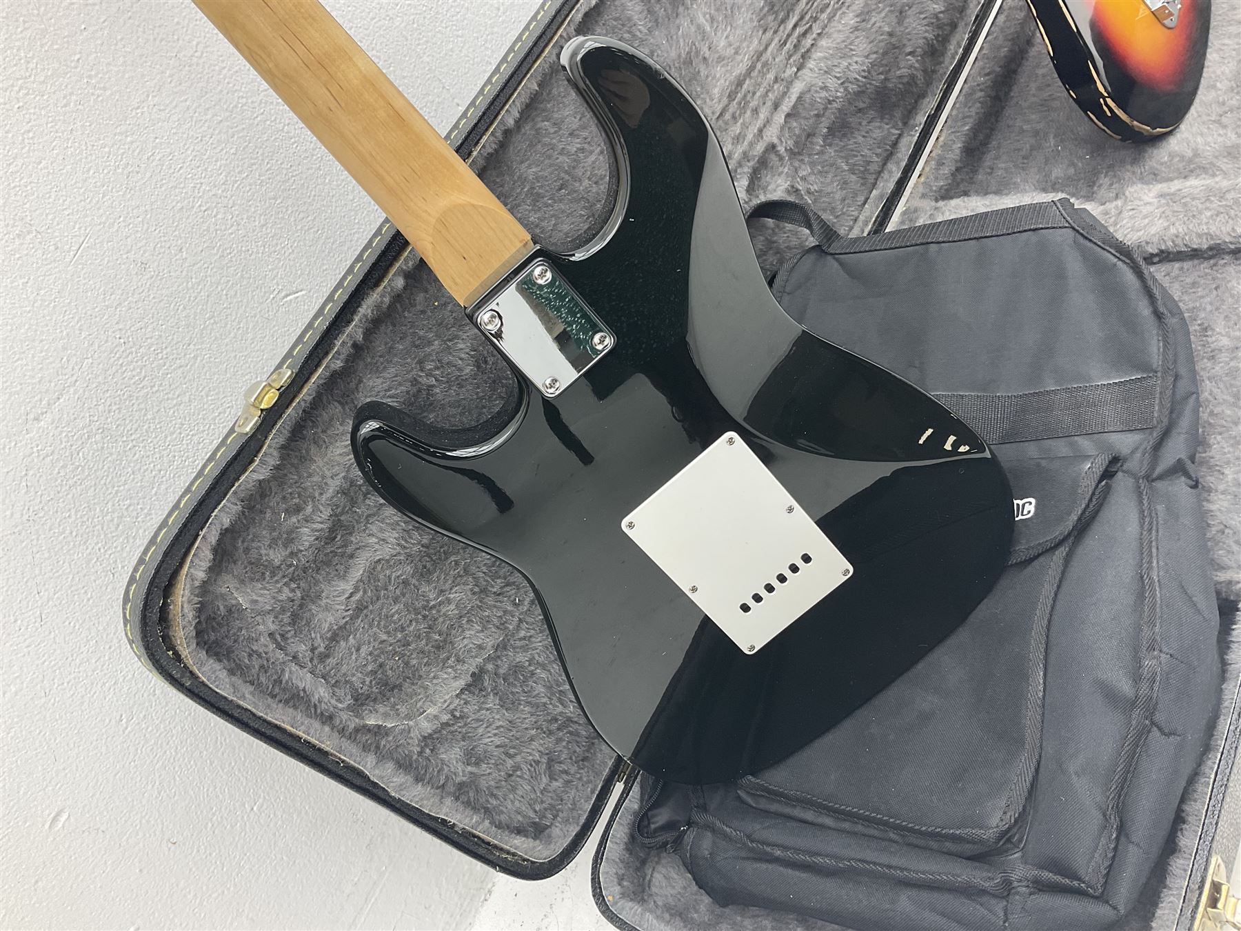 Fender style sunburst electric guitar with manuscript mark 'Zenta Stratocaster 1963' L97cm; in hard carrying case; another similar unmarked sunburst electric guitar; in gig bag; and Fender Frontman Amplifier, serial no.M473406 (3)