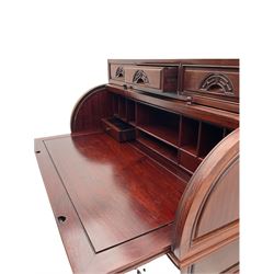 Hardwood cylinder desk, three drawers raised over curved lid, fitted interior with slide, the supports joined by undertier with fret work brackets 