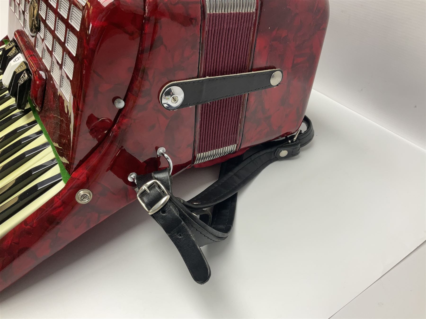 Hsinghai Studio piano accordion with red pearline finish, twenty keys and seventy-two buttons W44cm; in hard carrying case with additional The Music Room soft gig case