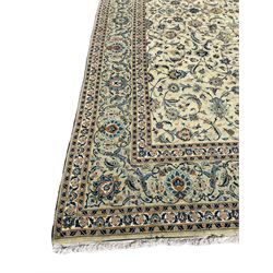 Persian Kashan carpet, light sage green ground, the field decorated all-over with interlaced foliate and plant motifs, repeating scrolled border with stylised flower head motifs