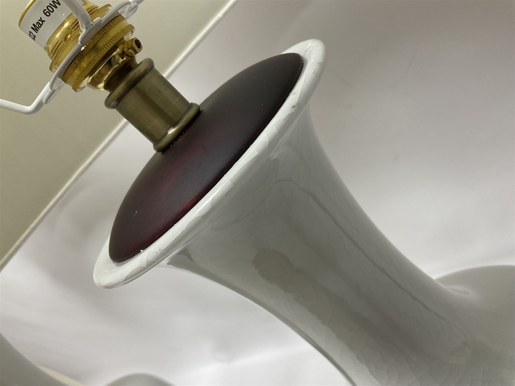 Pair of Chinese ivory crackle glazed table lamps, each of bottle form, raised upon circular hardwood base, excluding fittings H43cm