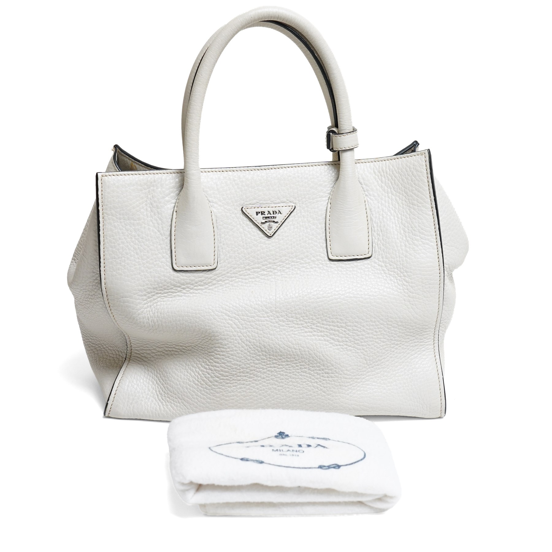 Prada - Vitello Daino shopping tote in Talco pebbled calf leather with contrasting black piping, the softly structured body with twin rolled handles, detachable and adjustable shoulder strap, zip fastening, silver-tone hardware and triangular Prada Milano logo plaque, with original product tag, authenticity card and dust bag