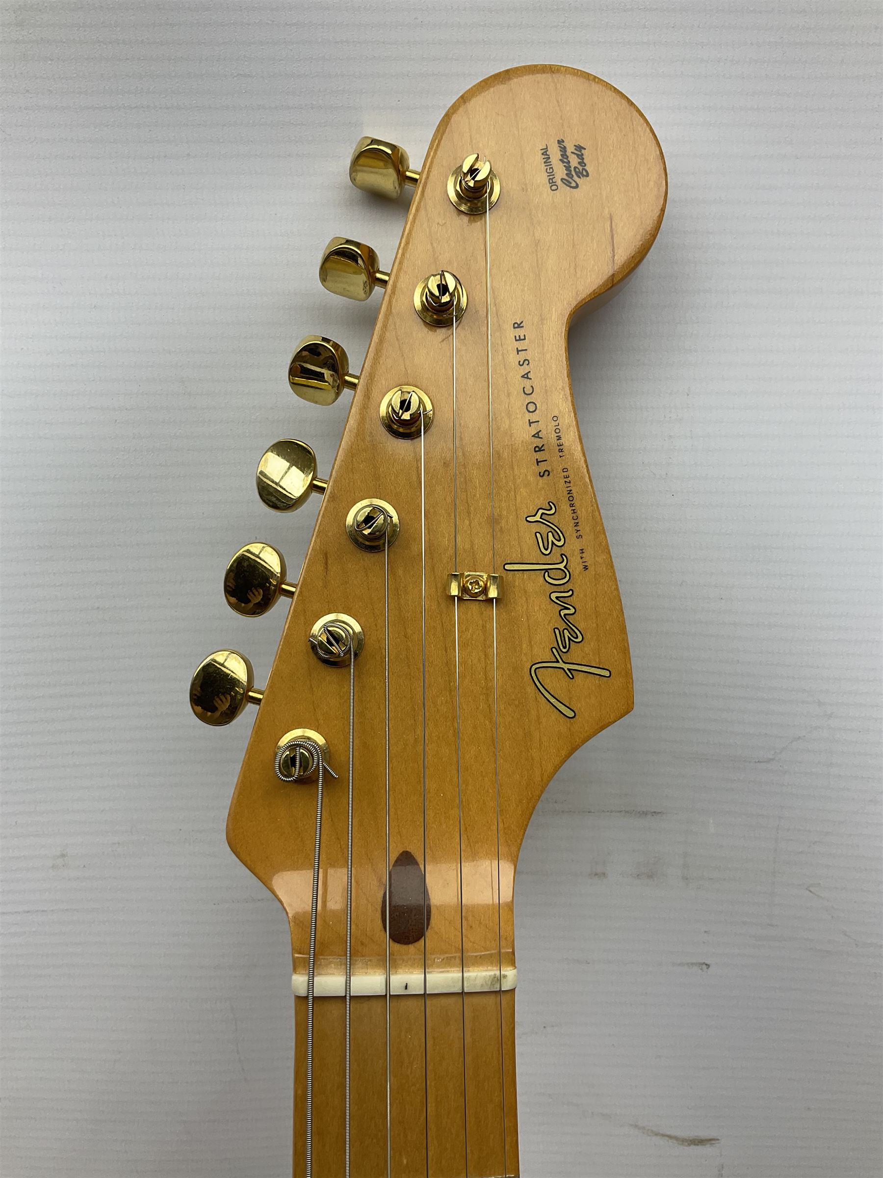 Fender Stratocaster 50th Anniversary 2004 metallic gold electric guitar; serial no.MZ4116369; L98cm; in Spider fitted case with owners manual and other paperwork, strap and belt buckle etc
