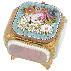 
Two Micro mosaic jewellery caskets with bevelled glass sides, the hinged lid decorated with raised flowers upon a blue ground, raised upon pierced gilt feet, largest H7cm 