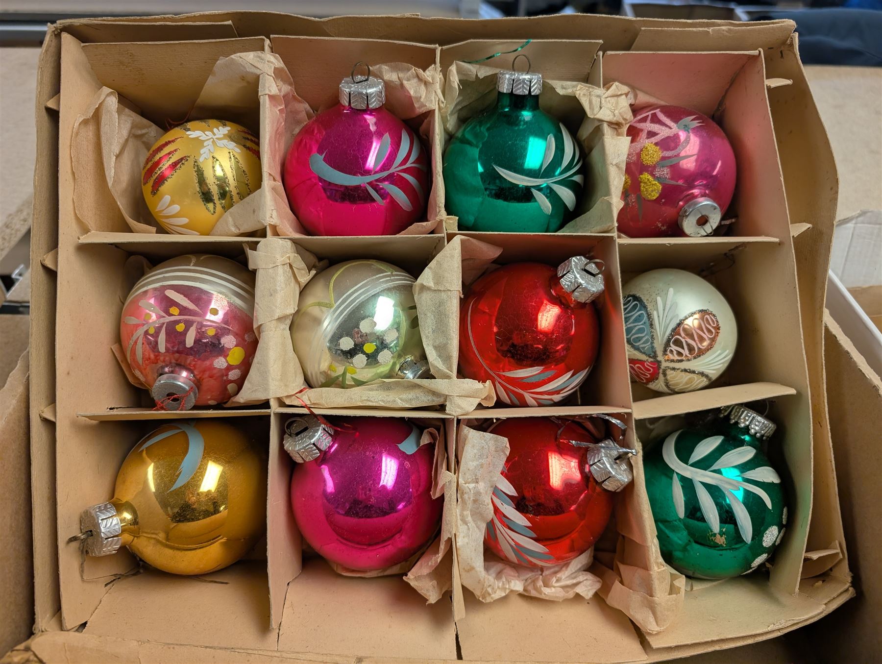Collection of colourful vintage Christmas decorations, including glass and metal baubles