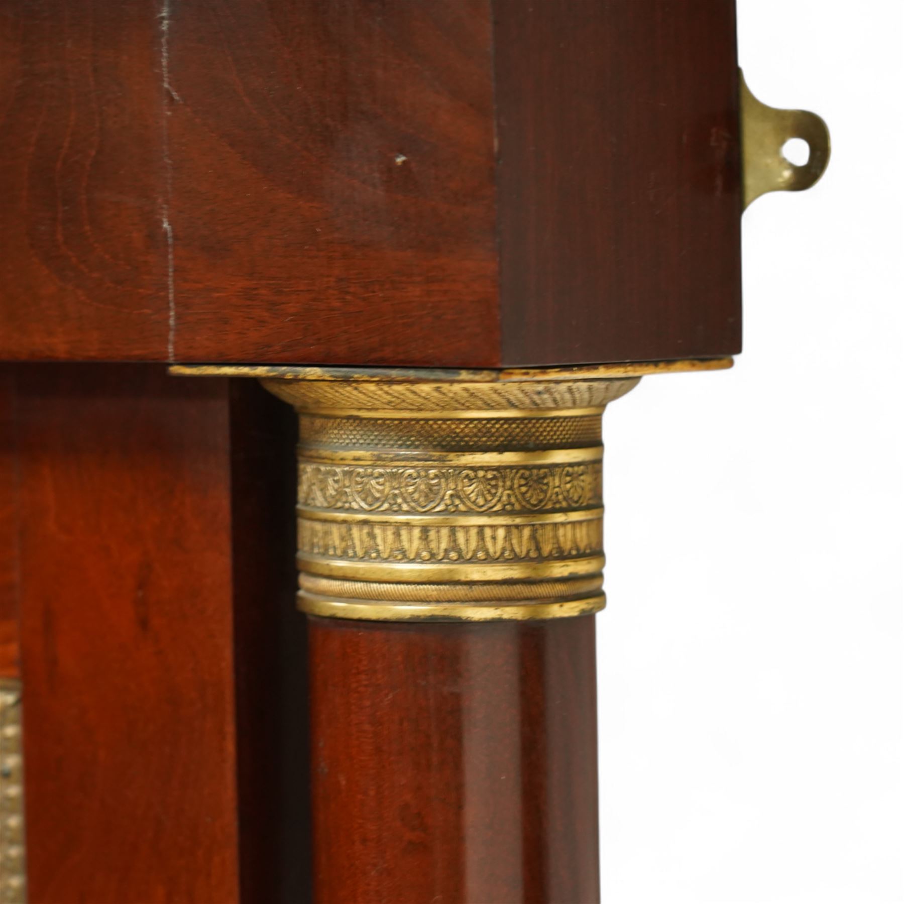 Rare pair of French Second-Empire neoclassical style mahogany mirrors with ormolu mounts, architectural pediment with central ormolu patera above flame mahogany frieze with honeysuckle flower and caryatid mounts, the frame with ormolu beading and bevelled mirror plates, flanked by turned columns with ormolu mounts above a reverse breakfront base, circa 1870