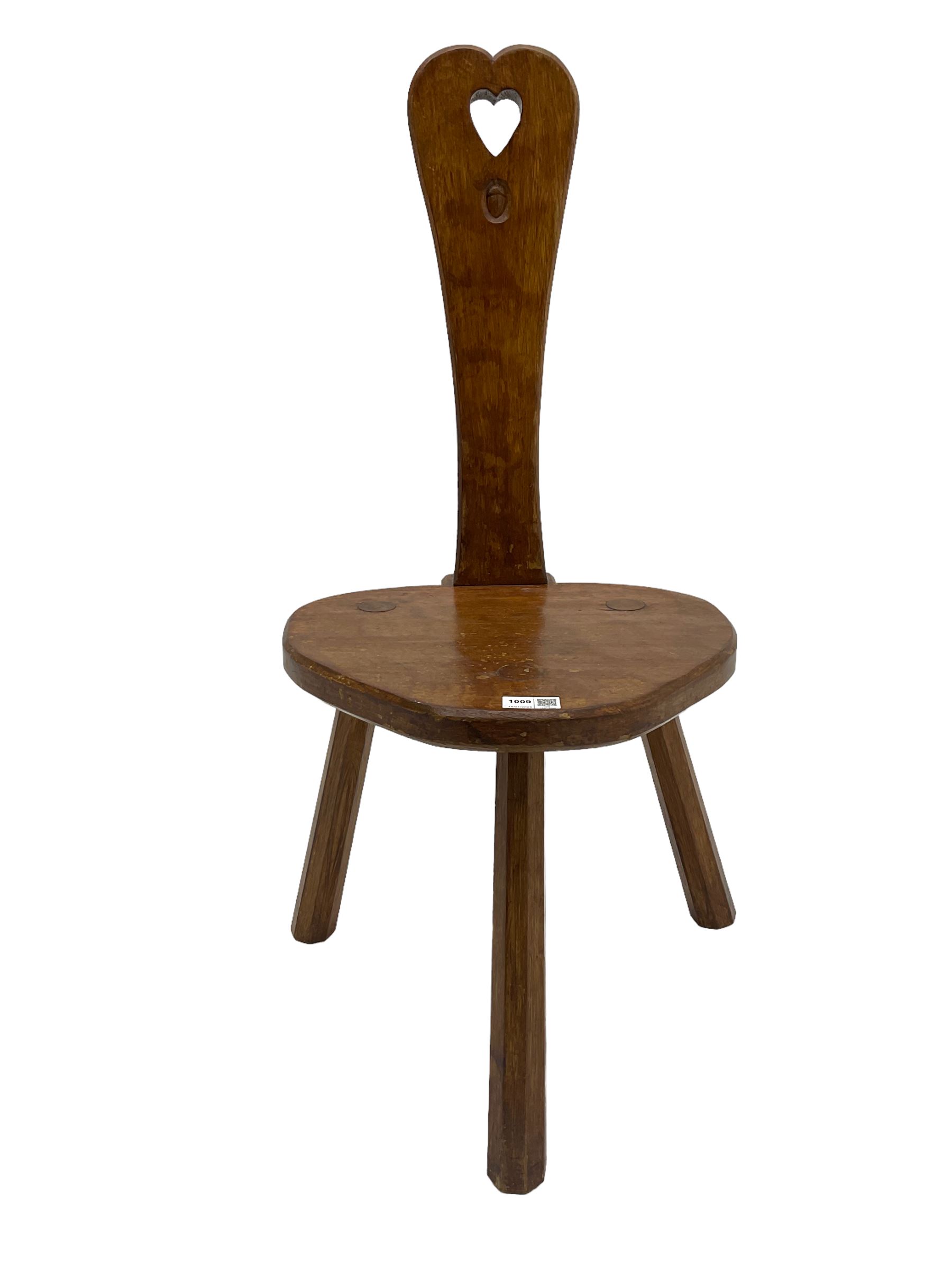 Acornman - adzed oak spinning chair, spoon shaped back with pierced heart and acorn signature, spade-shaped seat raised on octagonal tapering supports by Alan Grainger of Brandsby