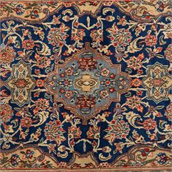 Persian Kashan rug, navy field with lobed central medallion and scrolling floral sprays, ivory spandrels within a palmette and vine border