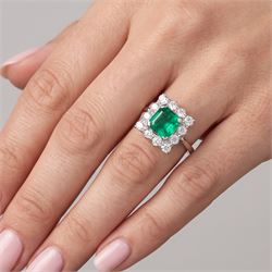 18ct white and yellow gold emerald and diamond cluster ring, single octagonal cut emerald of approx 1.55 carat, surrounded by twelve round brilliant cut diamonds, total diamond weight approx 0.95 carat