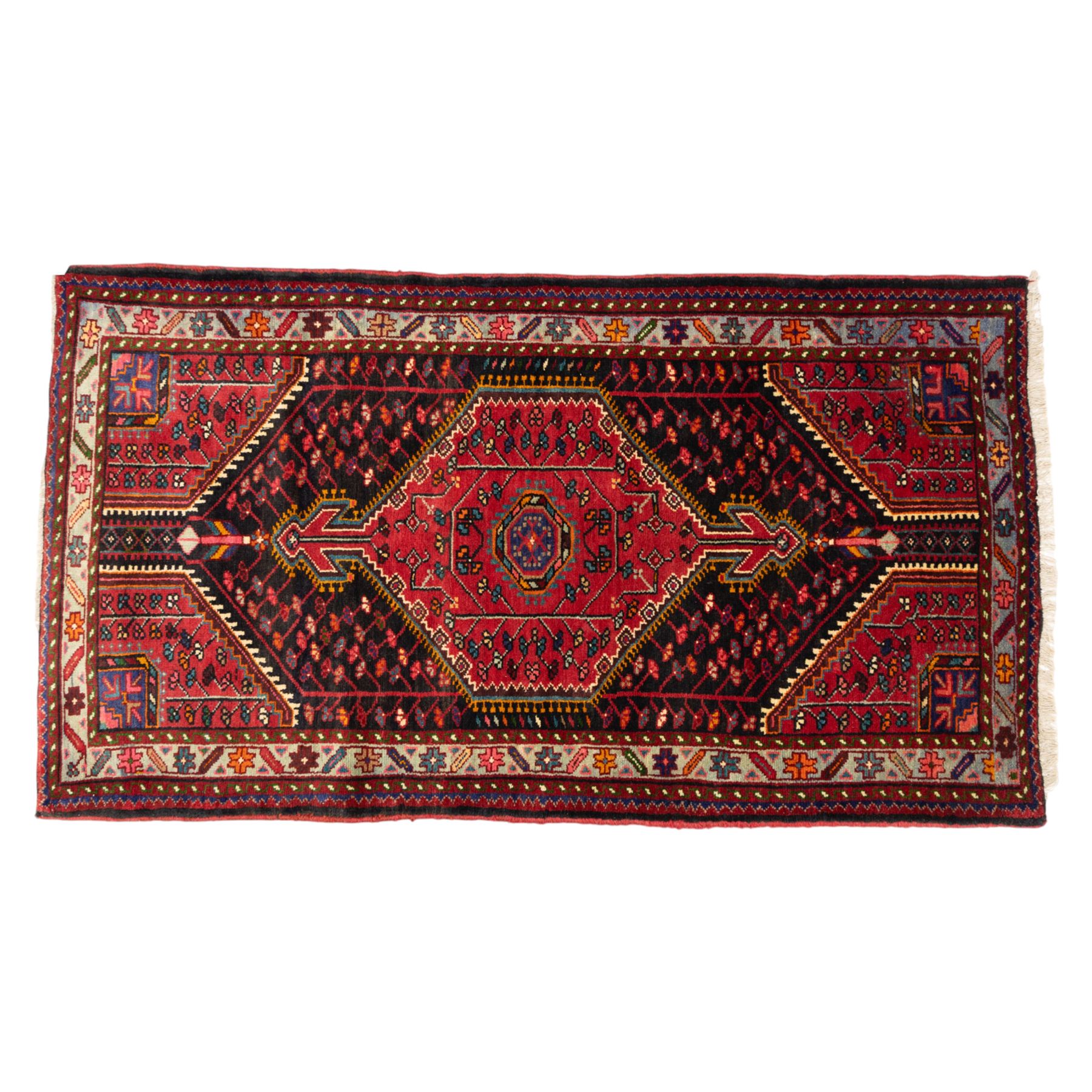 North west Persian Koliahee hand-knotted rug, central magenta field with elongated hexagonal medallion and arrow-shaped pendants over a dark lozenge-filled panels and stepped spandrels filled with boteh and floral motifs, corner square and cruciform devices within a pale olive border of stylized rosettes and angular vines between narrow guard stripes 