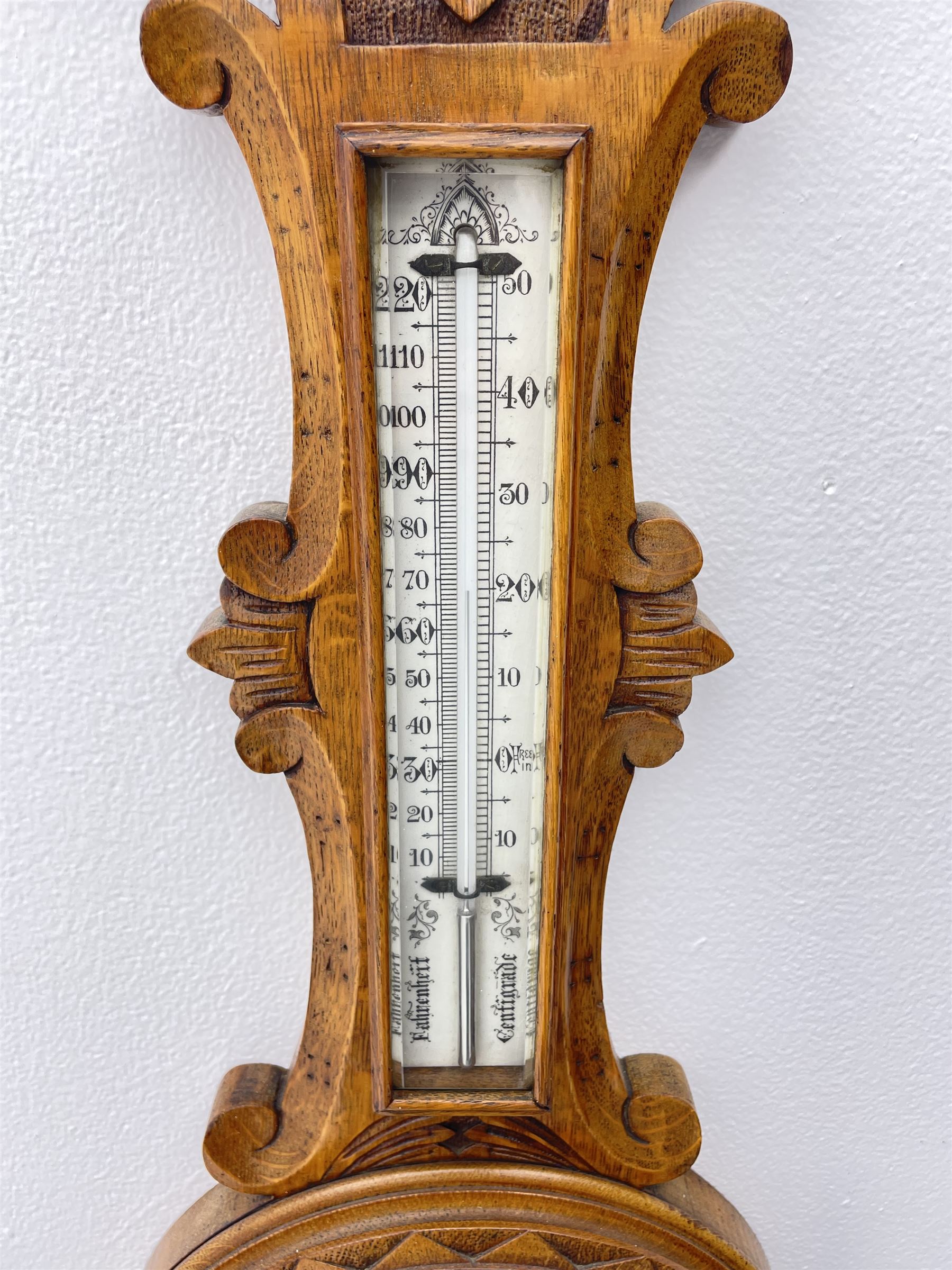 Early 20th century carved oak card aneroid barometer with visible