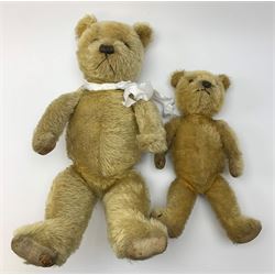 Two 1930s Chiltern type graduated teddy bears, one wood wool and one wood wool and kapok filled plush bodies, each with swivel revolving head, applied eyes and vertically stitched nose and mouth and jointed limbs, tallest H20.5