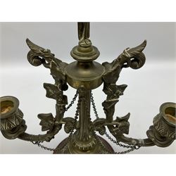 Pair of 19th century brass candelabra, each with circular spreading marble base leading to a shaped and tapering column with bird finial, flanked by twin curved and foliate detailed branches with sockets above shaped drip pans, H31cm