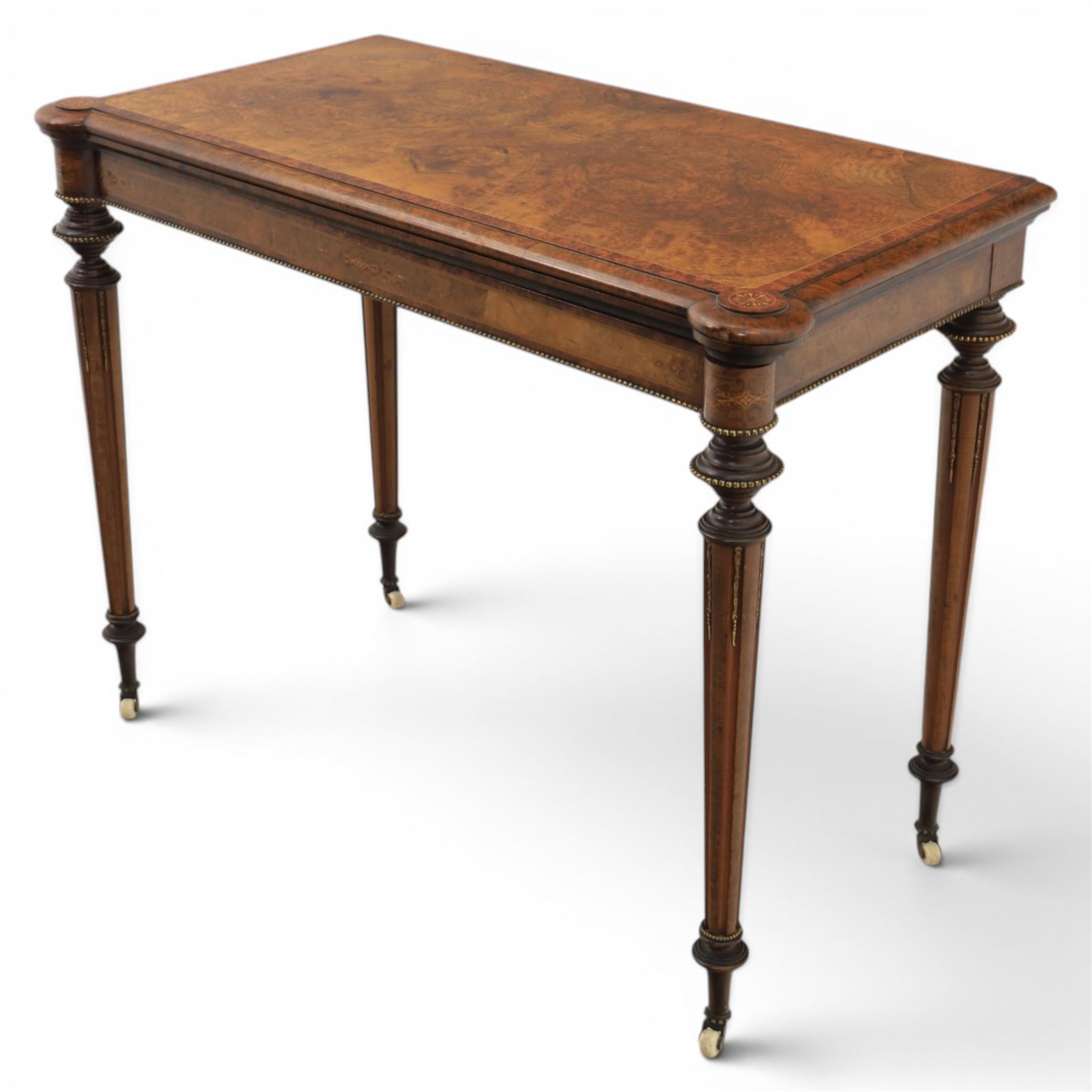 Victorian walnut card table, hinged rectangular moulded top with rounded corners and figured veneers, revealing a green baized lined interior, plain frieze with beaded lower edge, raised on ring turned tapering supports terminating in ceramic castors