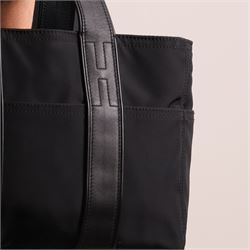 Hermès - Acapulco PM tote bag in black Toile Chevron canvas with black leather trim, the rectangular body with twin flat handles incorporating stitched H details, top zip fastening and eight exterior slip pockets, opening to a black nylon-lined interior with zip pocket, palladium-tone hardware, stamped Hermès Paris Made in France, with original Hermes dust bag