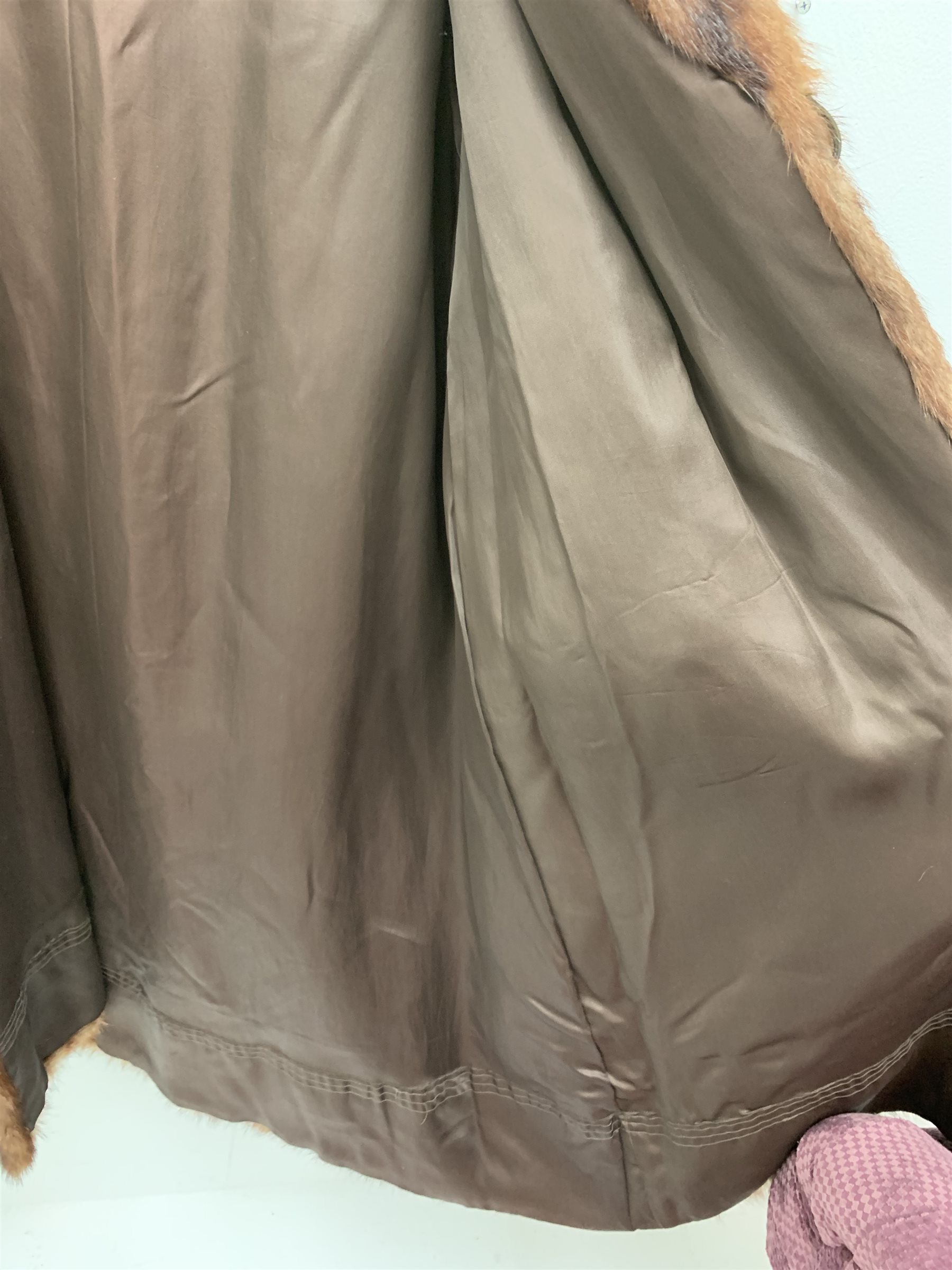 A lined Musquash fur coat. 