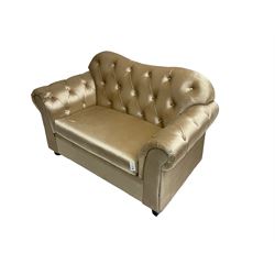 Chesterfield shaped snuggler sofa, upholstered in buttoned champagne fabric, with scatter cushions