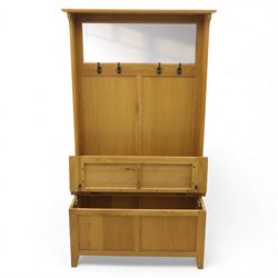 Modern light oak hall bench settle, with moulded cornice above a panelled back fitted with a row of metal coat hooks, over a hinged box seat opening to shoe storage, on tapered legs