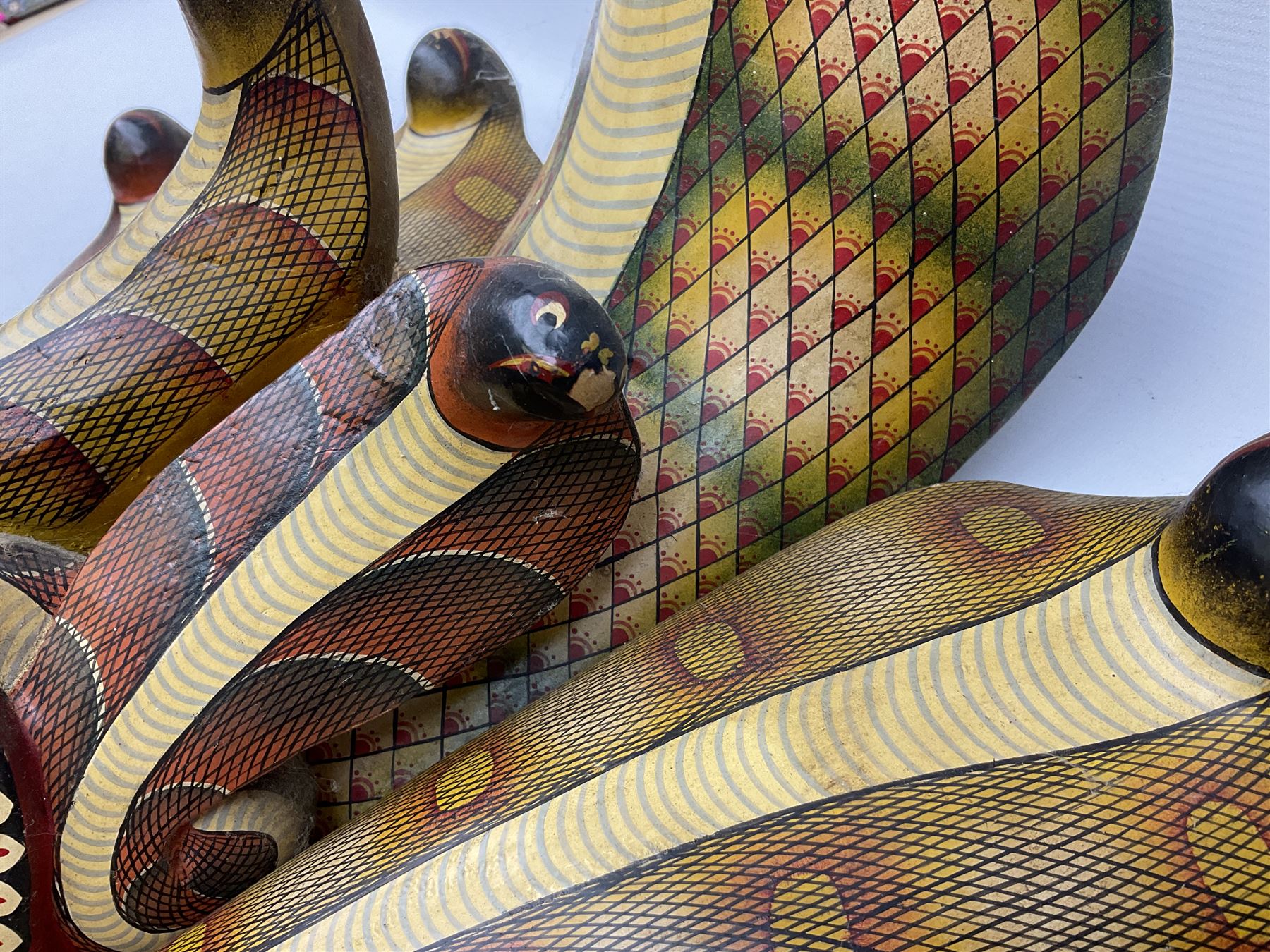 Sri Lankan Cobra mask depicting the demon Naga Raksha, together with a smaller example, largest H46cm