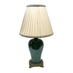 Green baluster form crackle glaze table lamp, with ornate brassed base and pleated fabric shade
