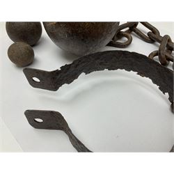 Late 19th/early 20th century prisoners iron ball and chain, with leg manacle; small cannon ball and grape shot