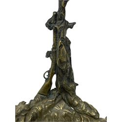 Pair of cast brass hallway umbrella or stick stands, in the form of a tree decorated with trailing flowering foliage branches, the stem with hunting horn over leaning shotgun, shaped naturalist tray base with hunting hound and out splayed foliate cast feet 