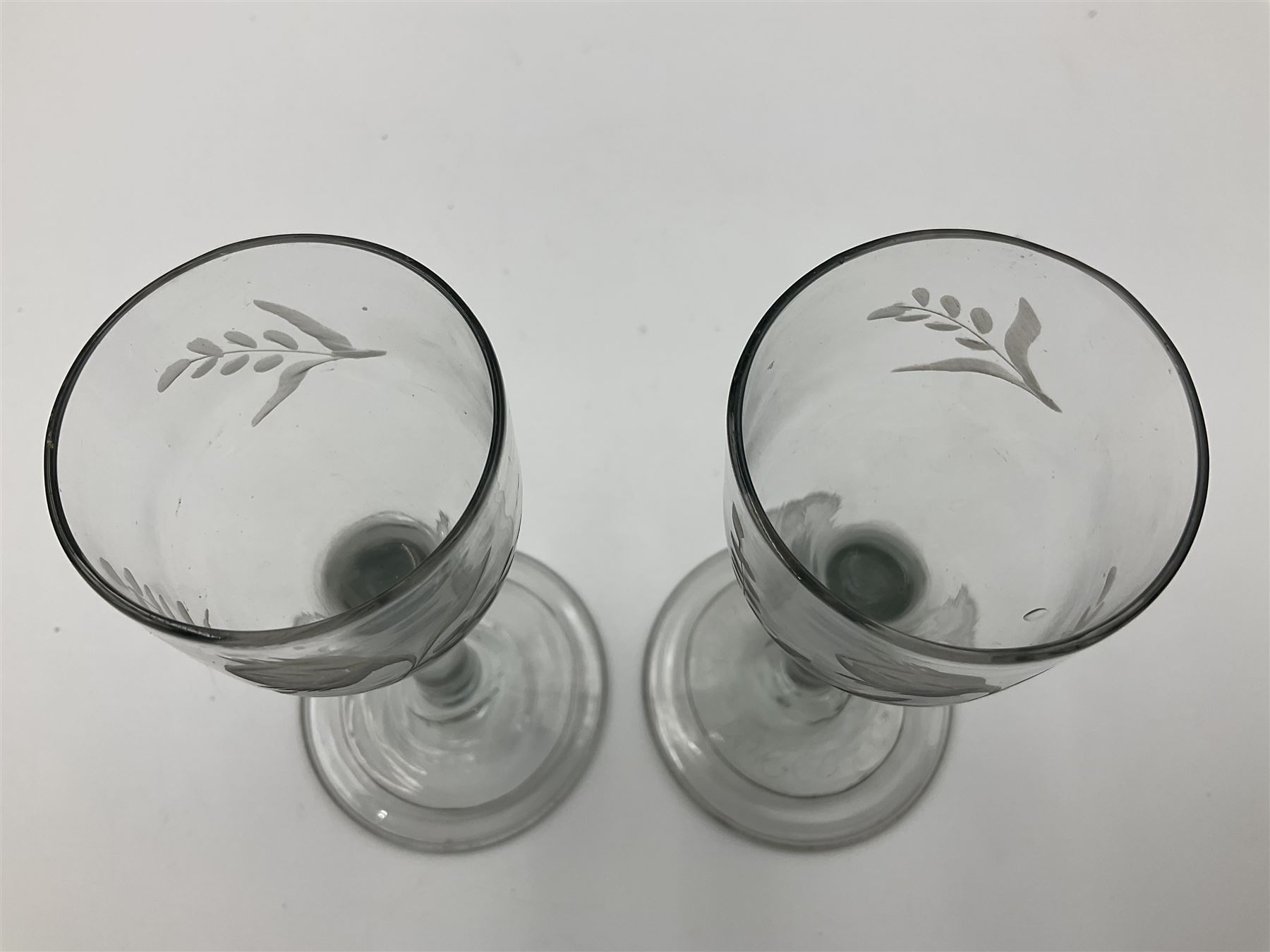 Pair of 18th century Jacobite style wine glasses, the ogee shaped bowls engraved with a single rose and sprig, plain stems upon conical folded feet H13cm