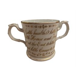 Pair of Art Deco dog bookends and a twin handled loving cup, painted with floral decoration and quote, loving cup H14cm