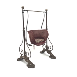  Victorian child's cast iron garden swing, shaped seat on curved supports, the frame with ball finials, scrolled detail and lotus cast feet, H132cm, W80cm  