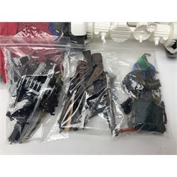 Action Man - large collection of 1960s and later figures and accessories including Spaceman with ATLRV vehicle; two figures marked 'Made in England by Palitoy under licence from Hasbro 1964'; twenty-five assorted weapons; radio backpacks; kit bags; twenty-one pairs of boots; football boots and snow shoes; metal diver's boots and three pairs of flippers; two pairs of jackboots; roller skates; various tunics, trousers, flying suits, jumpers, belts etc; twenty helmets, berets, busby, kepis, submariner etc; and quantity of other accessories