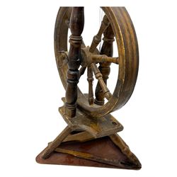 Late 19th century turned beech spinning wheel, upright form with single treadle, triangular base, and a flyer and bobbin assembly surmounted by a turned finial.