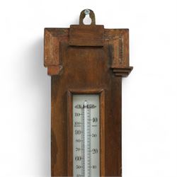An English 20th century aneroid barometer with a slivered dial and surface mounted mercury thermometer.
