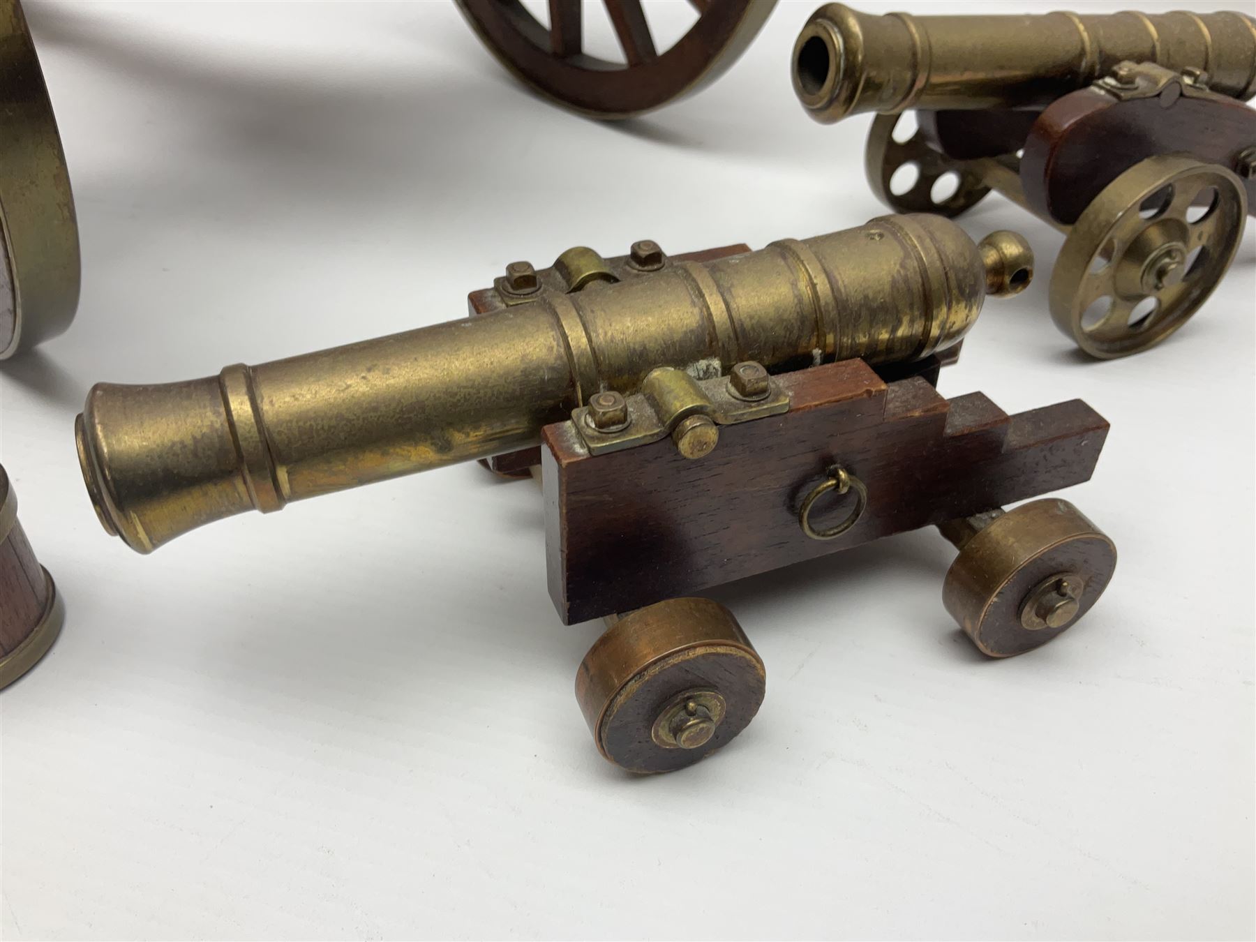 Large model brass cannon, upon wooden base, together with two similar smaller cannons, largest L48cm