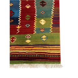 Late 20th century Louis De Poortere Belgian Shalamar wool ground rug, featuring a vibrant multi-coloured geometric design with stacked rectangular borders surrounding two central medallions, finished with fringed ends
