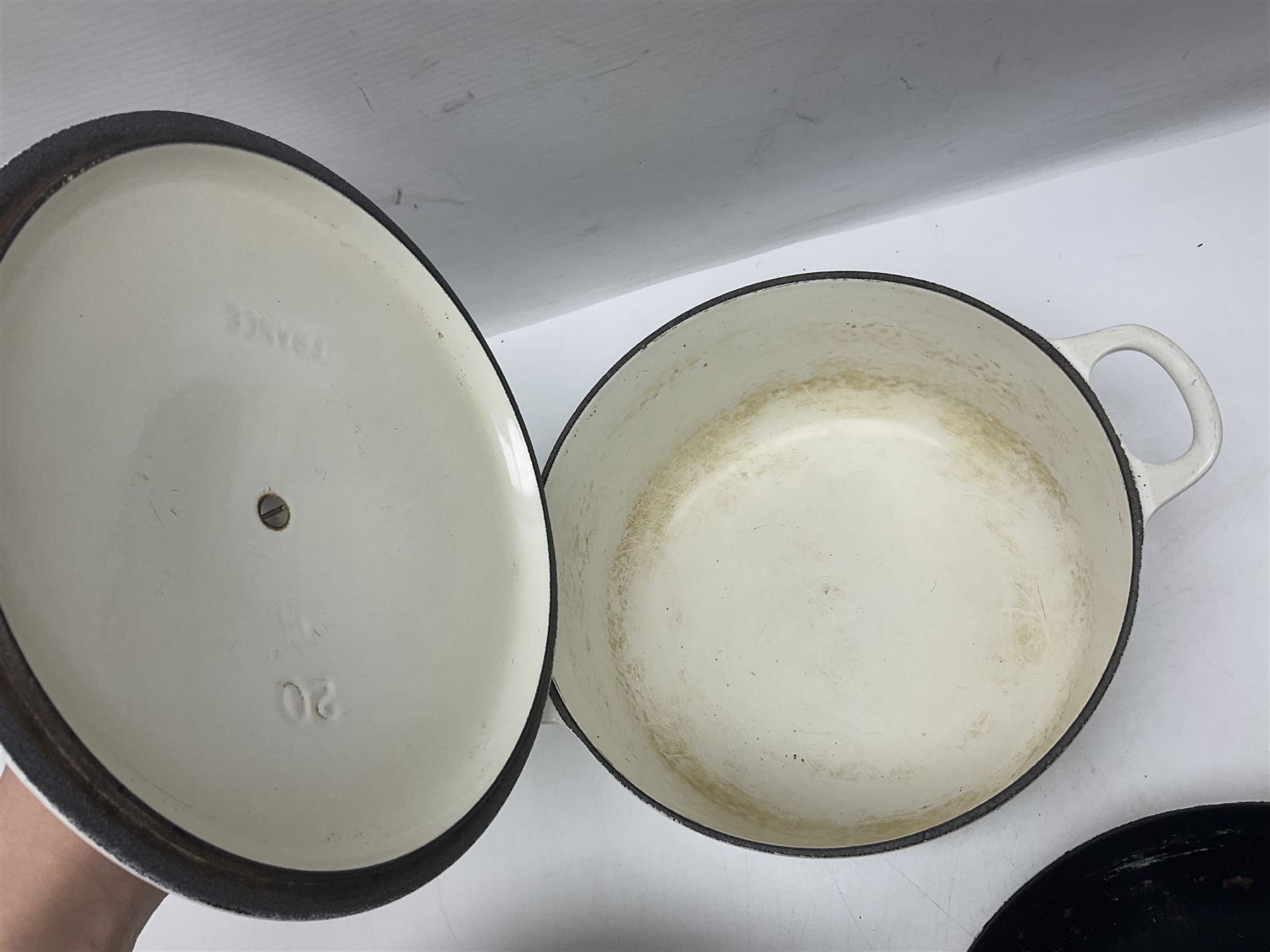 Le Creuset cast iron casserole dish, together with two Waterford cast iron dishes and a frying pan