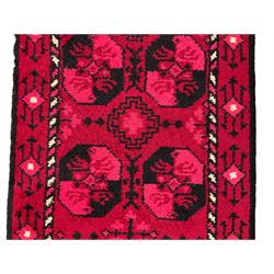 Western red ground rug, the field with Gul design motifs, within a geometric border