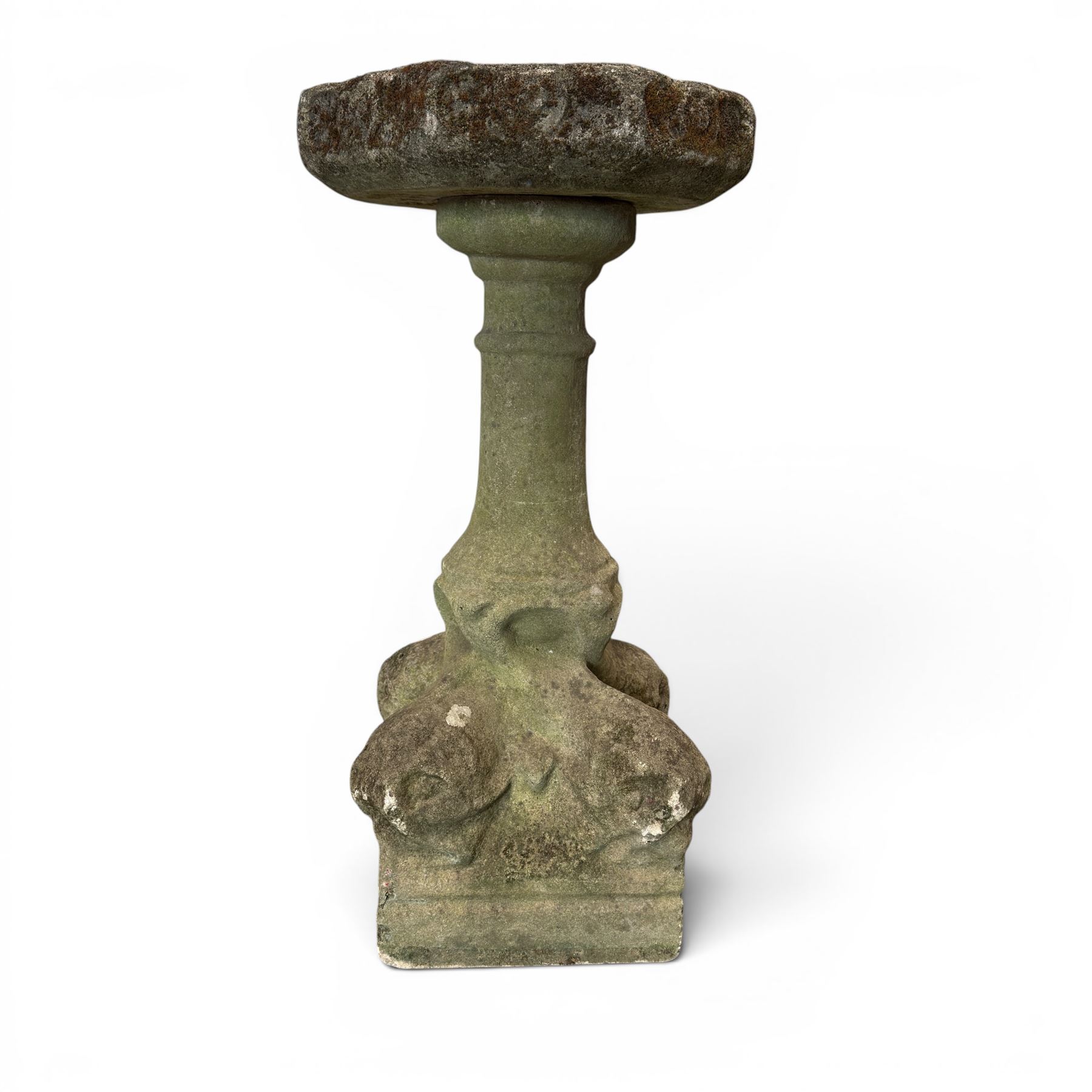 19th century weathered sandstone birdbath, the octagonal canted dished top raised on a ring turned flared pedestal, with four carved stylised dolphins to the squared base