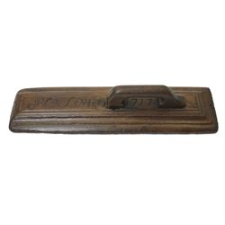 18th century oak mangle board, carved with scrolled motifs, incised 'ANNO 1717', W57cm 