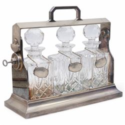 Mappin & Webb silver plated tantalus, with three square glass decanters each with silver plate collars, complete with key, H29cm