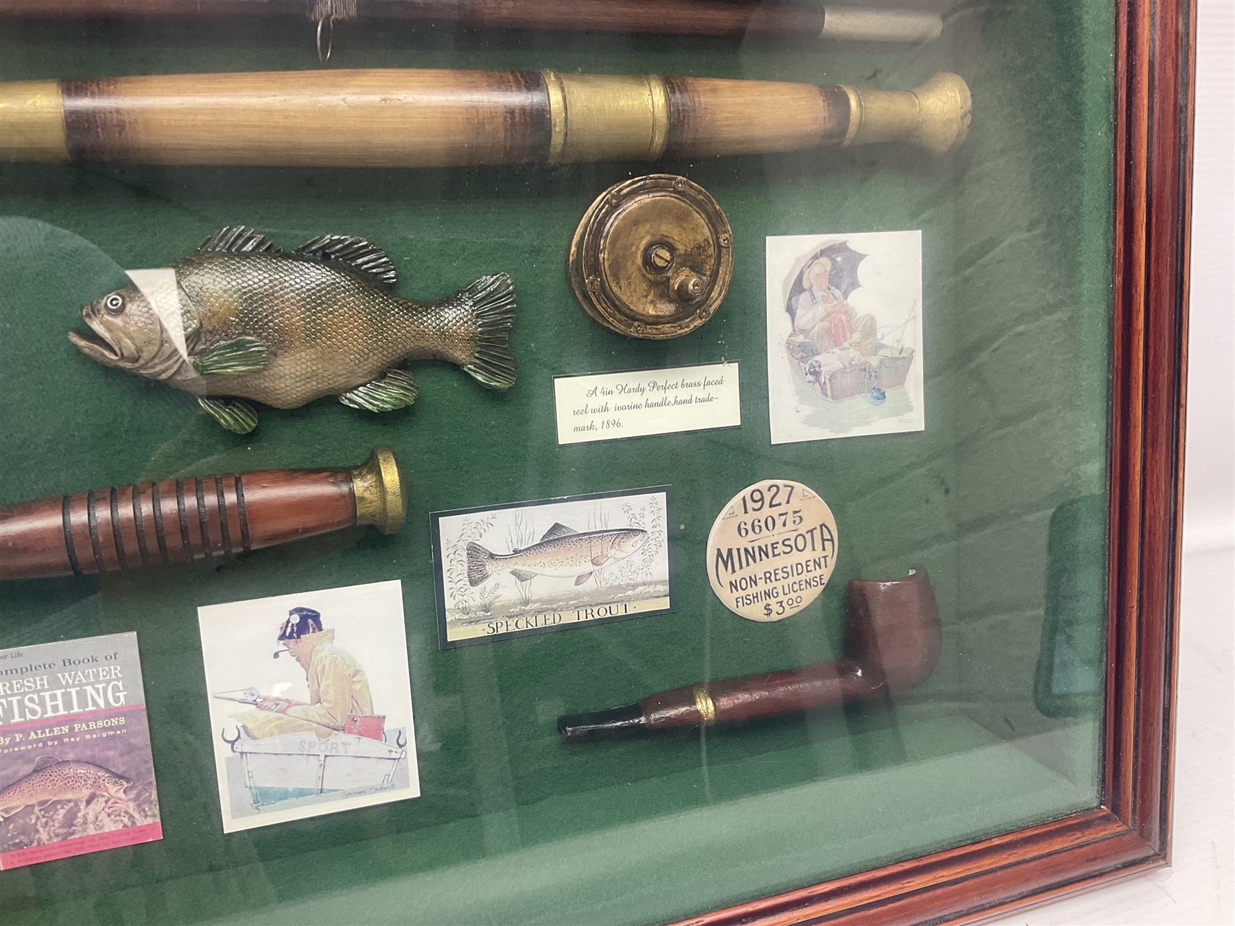 Four framed sporting memorabilia displays, the largest example containing 1930s cricket memorabilia, together with two fishing displays and a football display, each within wooden glazed frames, largest H105cm