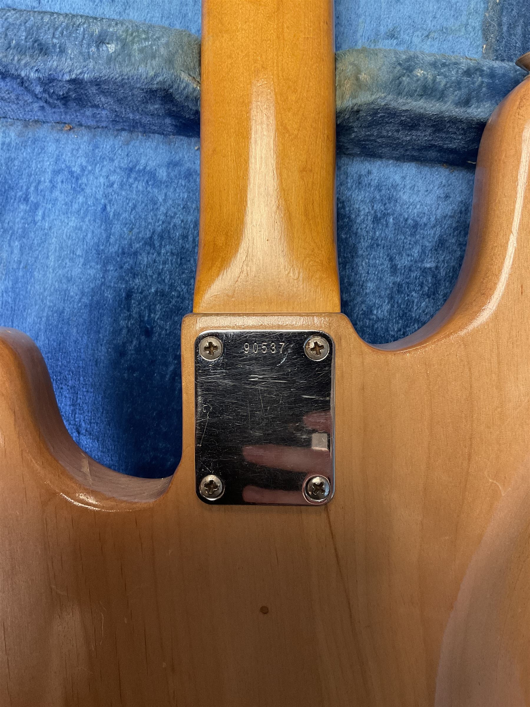 1962 Fender Precision bass guitar; re-finished in natural alder in the 1970s; impressed date code 5NOV62C to end of neck and serial no.90537 to back plate; L115.5cm; in replacement hard carrying case